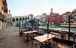 empty tables by the Rialto bridge in Venice