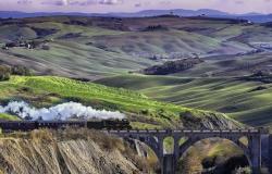 The Val D'Orcia steam train crossing the Tuscan hilly landscape
