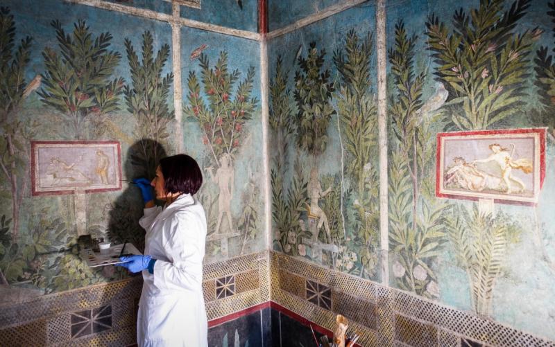 Restorer working on fresco in Pompeii