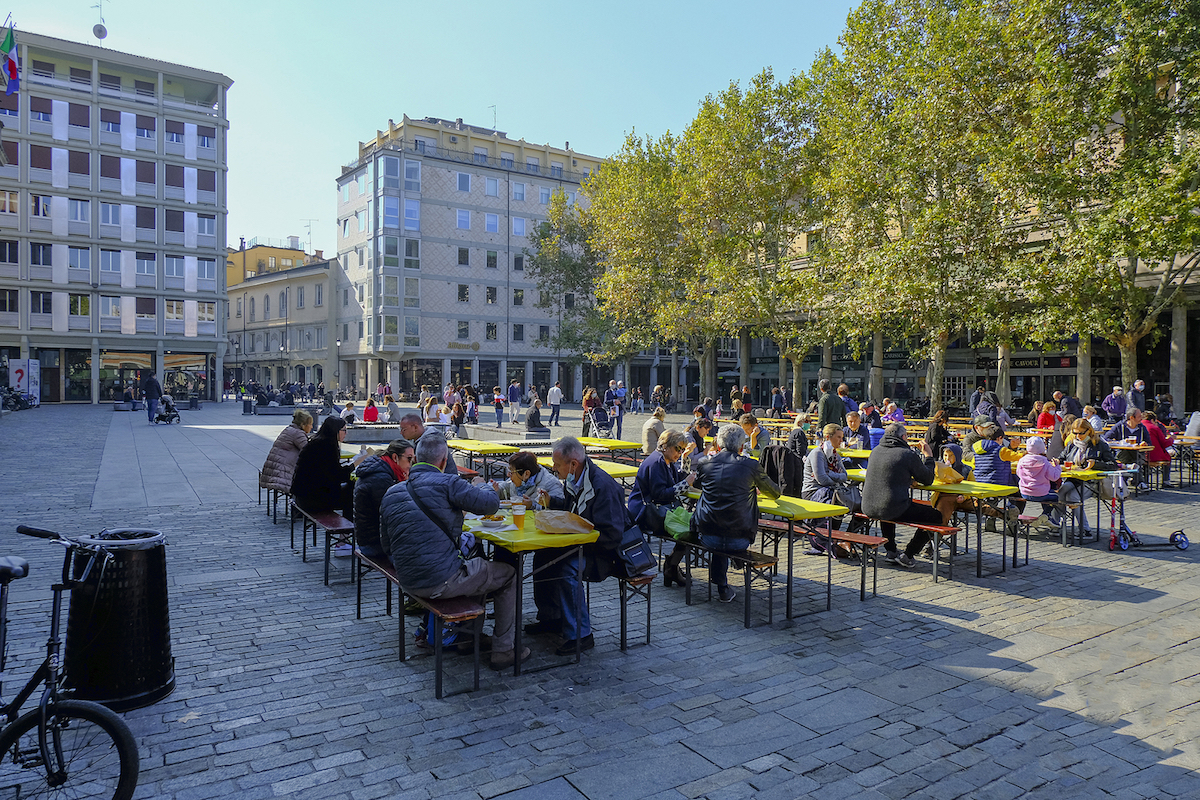 Street food festival. People on the square of the city eating street food meals