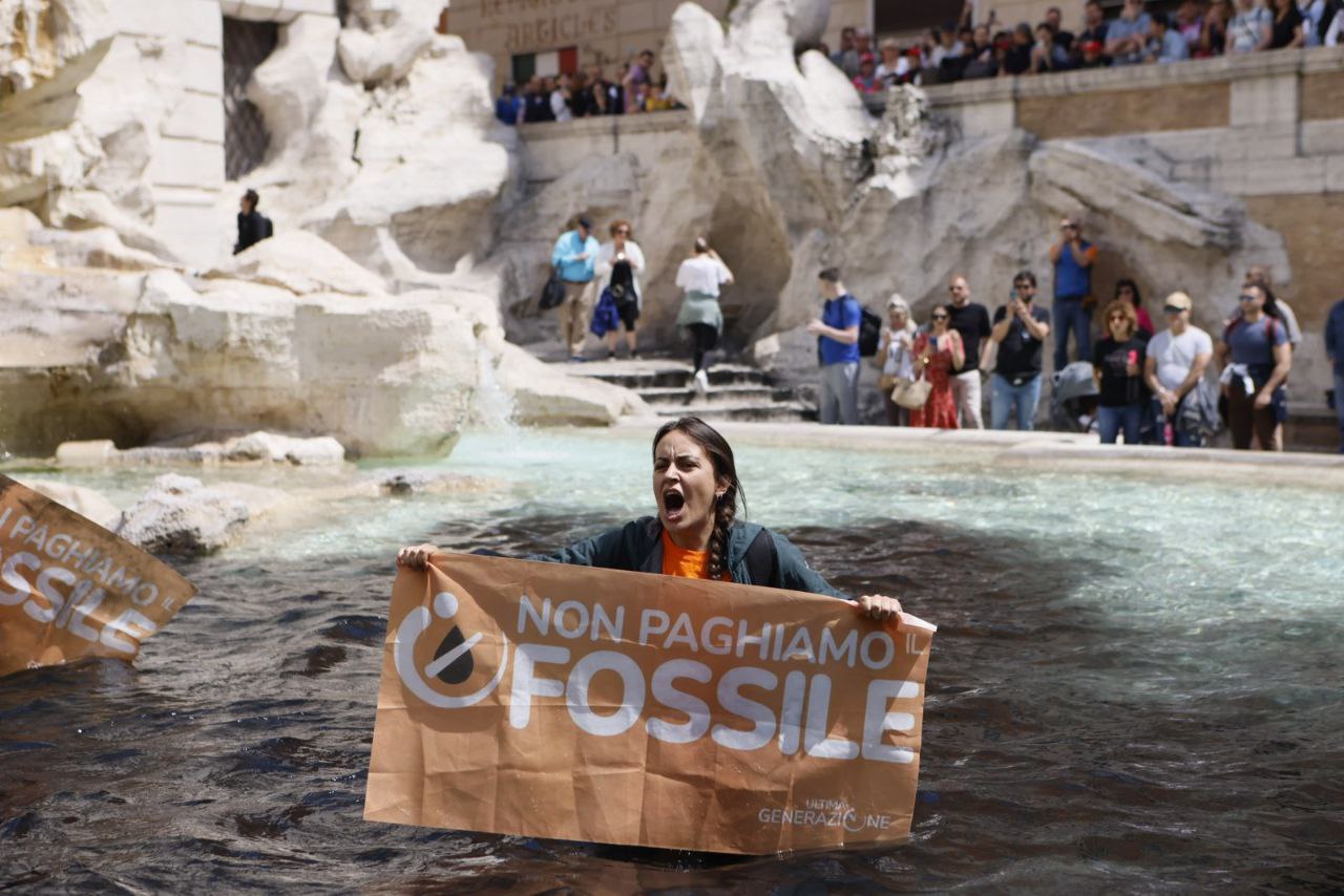 A Last Generation activist stands in the Trevi Fountain