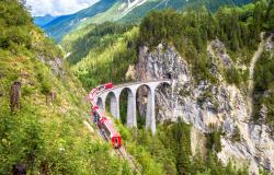 The Bernina Express red train passing through the Alps 