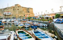 Castel dell'Ovo and harbor with boats in Naples
