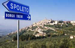 Road signs in Umbria with village in the background