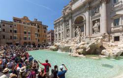 Tourist crowds in front of the Trevi Fountain in Rome
