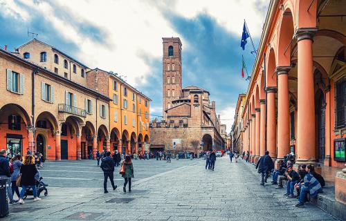 People walking on a street in Bologna and portico