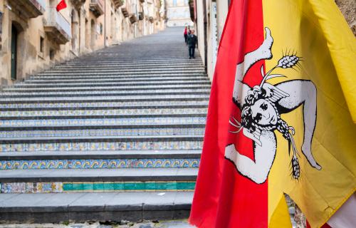 The flag of Sicily and the famous staircase of Caltagirone behind it