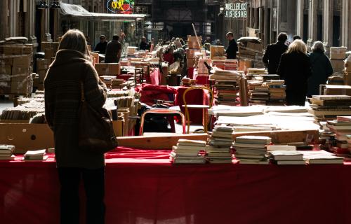 A woman browses at a book fair held in the Mazzini Gallery in Genoa