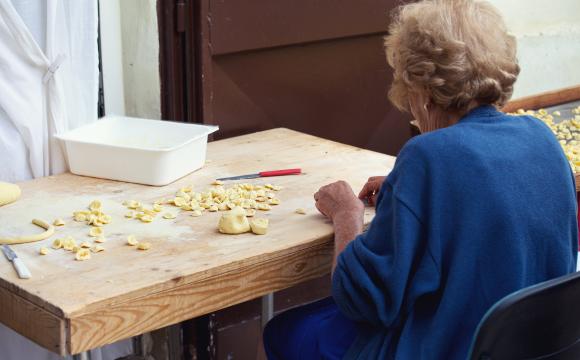 Woman making traditional orecchiette pasta in Bari, Puglia
