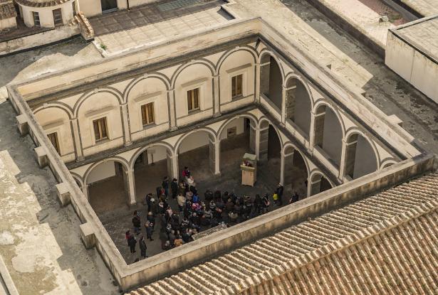 View of the Certosa di San Martino with visitors grabbed in the court View of the Certosa di San Martino with visitors grabbed in the court