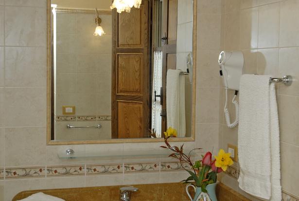 Marble vanities, fully-tiled bathrooms in all bedrooms a typical en suite bathroom in all the guest rooms/bedrooms