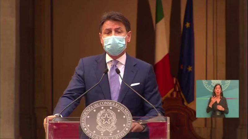 Italy's premier Giuseppe Conte wearing face mask during press conference