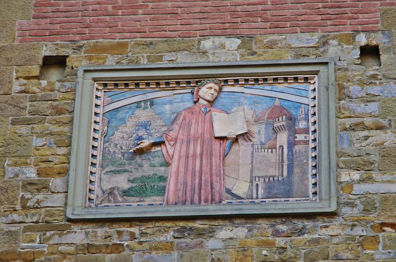 Plaque depicting Dante on a wall in the streets of Florence