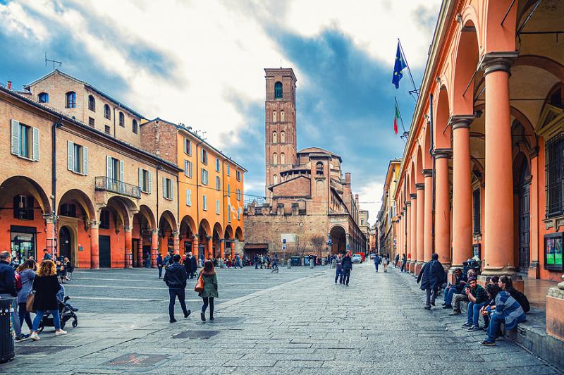 People walking on a street in Bologna and portico