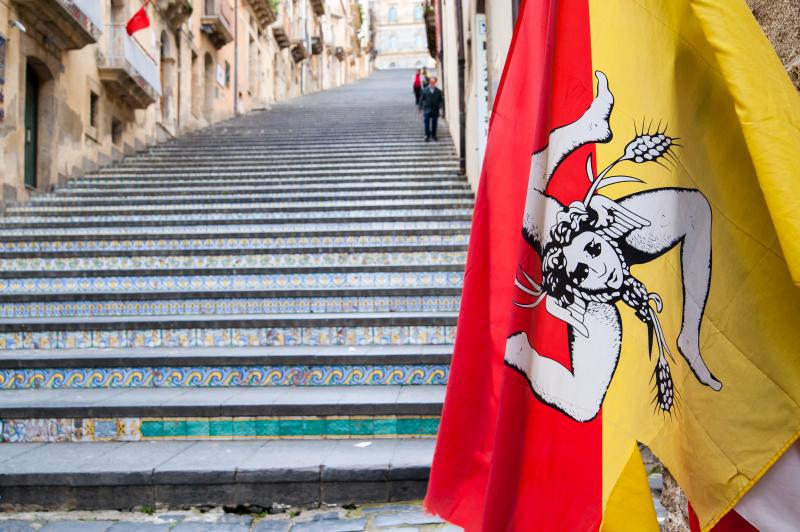 The flag of Sicily and the famous staircase of Caltagirone behind it