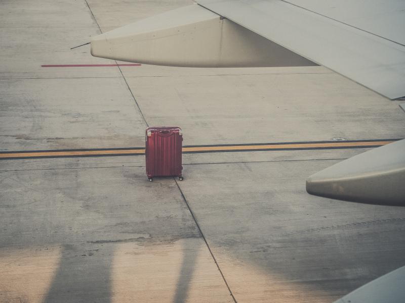 A lone lost suitcase on a runway in Rome
