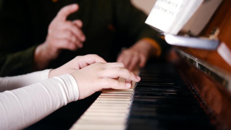 Piano teacher gives instructions