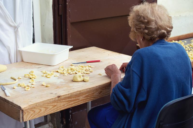 Woman making traditional orecchiette pasta in Bari, Puglia