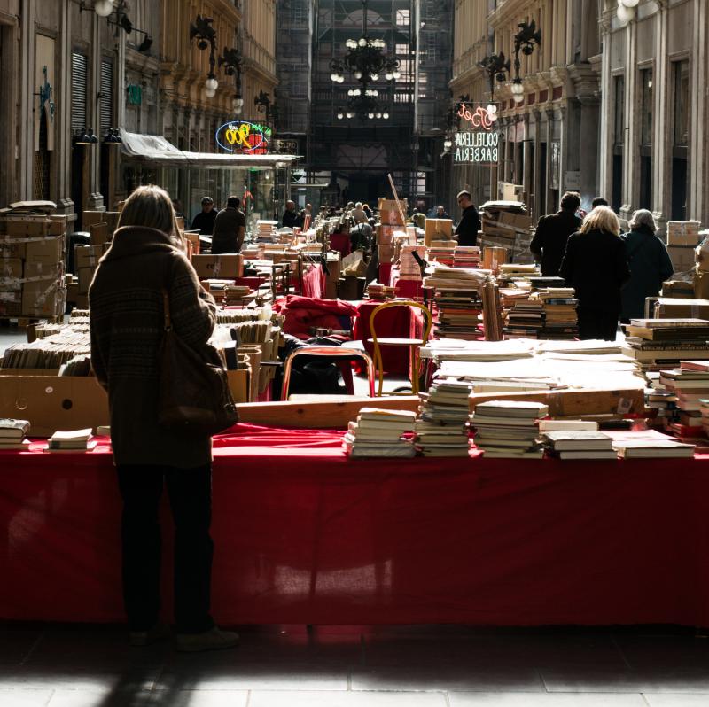 A woman browses at a book fair held in the Mazzini Gallery in Genoa