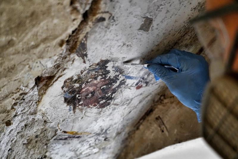 A restorer works in the "secret" staircase of Palazzo Vecchio