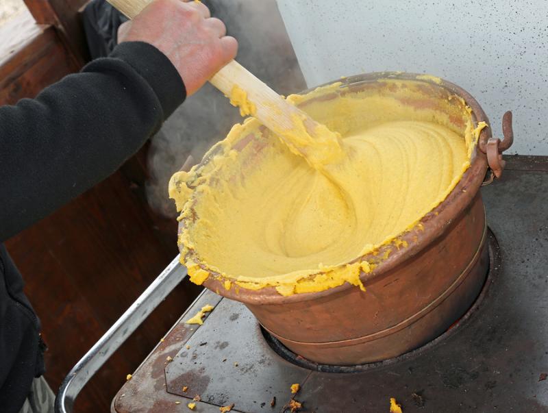 stirring polenta in large pot