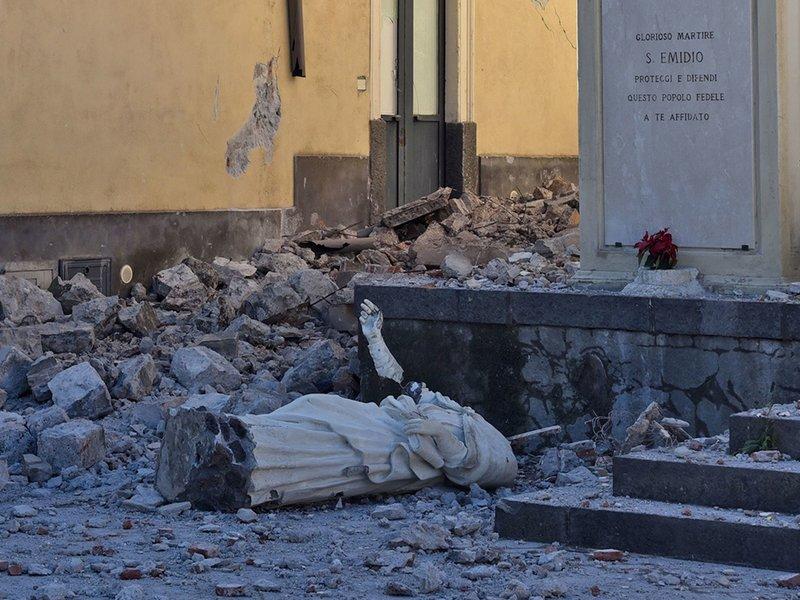 Toppled statue and rubble in Sicilian village after earthquake struck