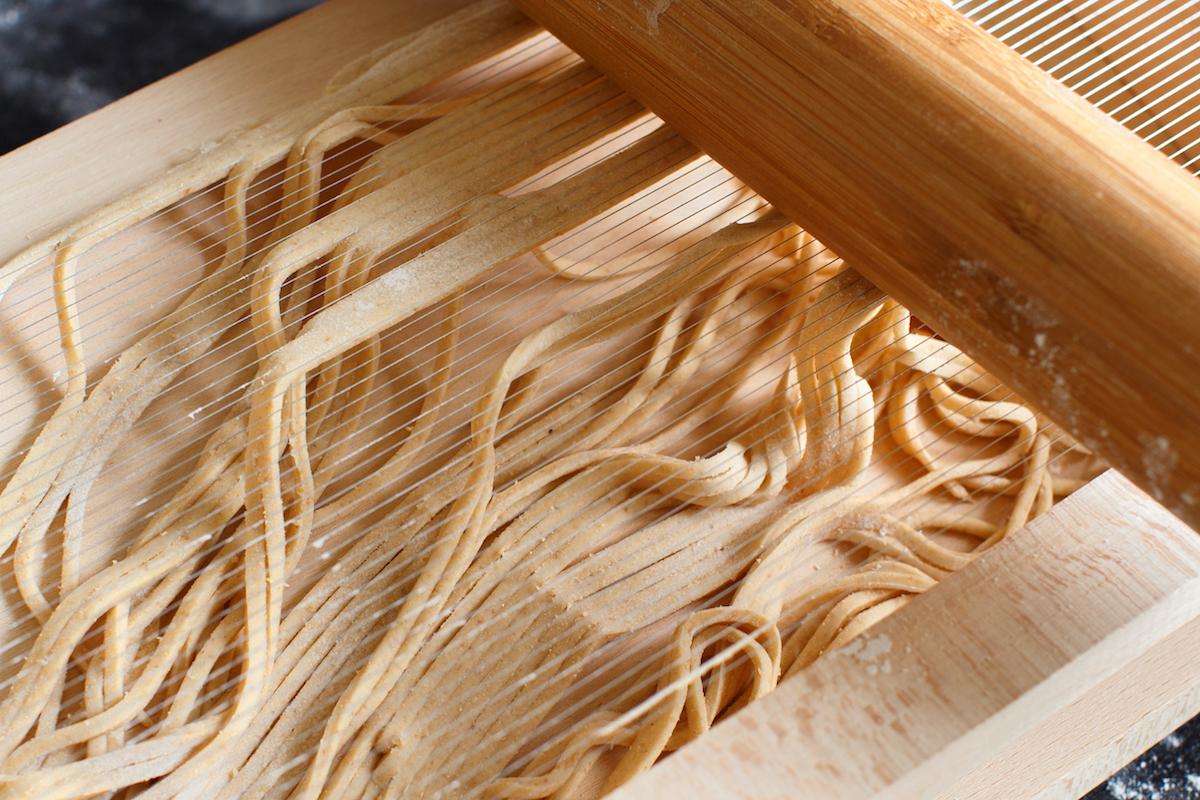 Making spaghetti alla chitarra with a tool - specialty of Abruzzo region